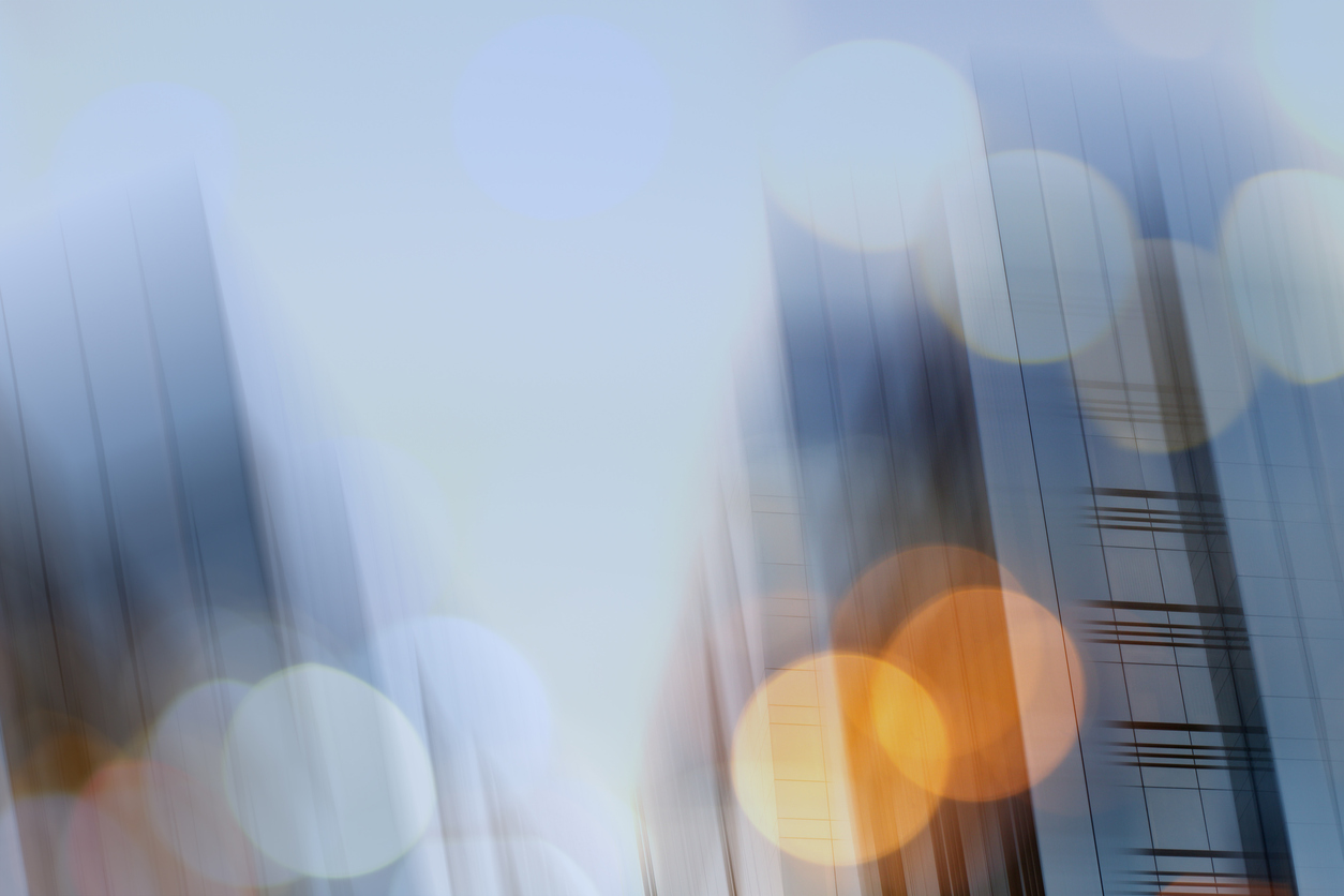 Abstract business modern city urban futuristic architecture background. Real estate concept, motion blur, reflection in glass of high rise skyscraper facade, toned blue picture with bokeh